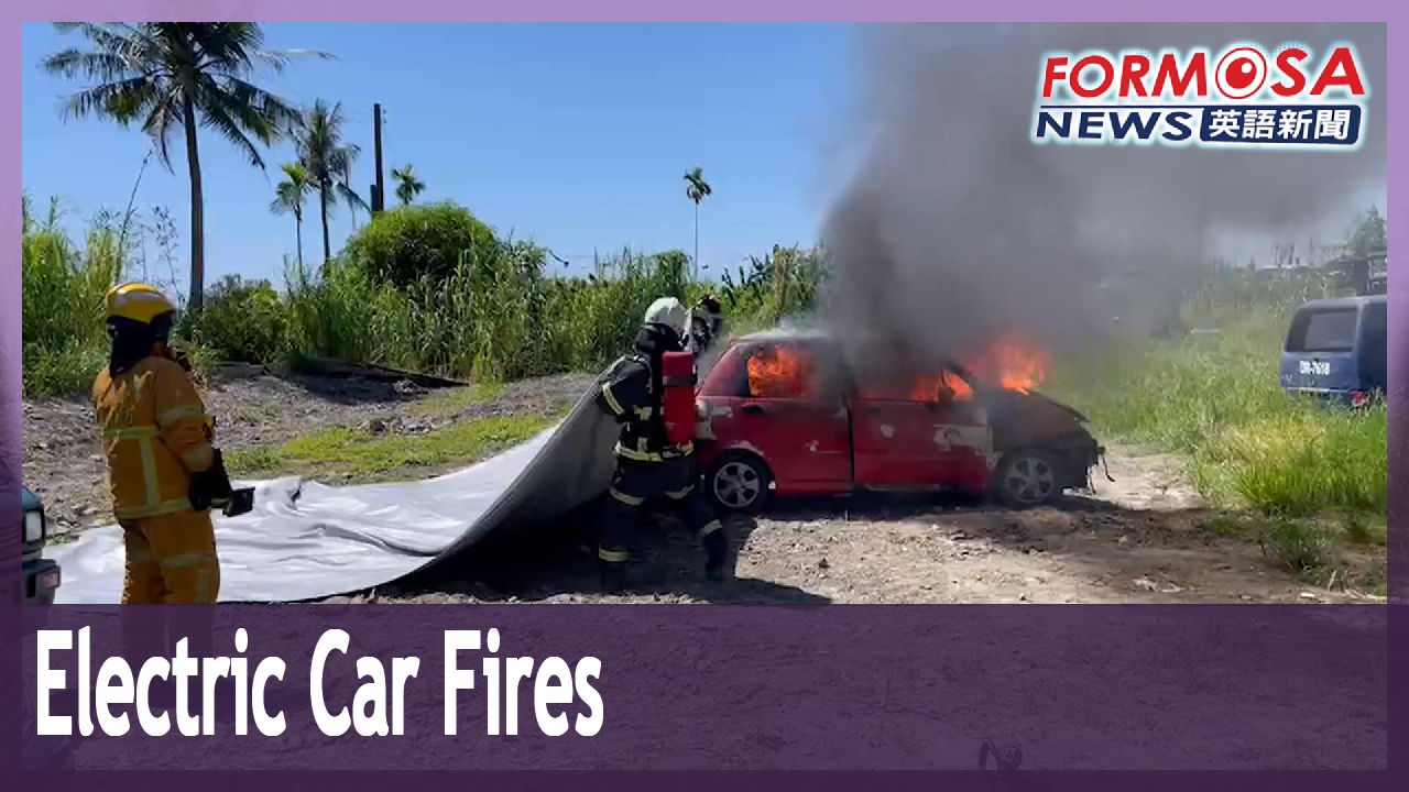 Fire fighters use fire blankets to extinguish electric car blazes