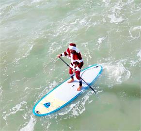 佛羅里達可可海灘耶老衝浪日　衝浪客化身耶誕老人、小精靈下海同樂